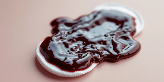 Close-up of brown period blood on a sanitary pad.