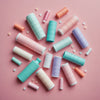 Various reusable menstrual products on a pastel backdrop.