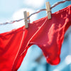 Close-up of vibrant red underwear on a clothesline.