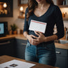 Woman clutching stomach, calendar behind, pre-period signs