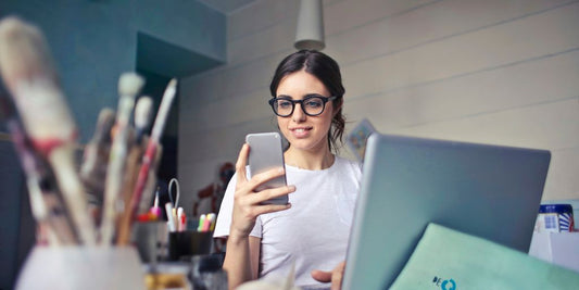 woman in white shirt using smartphone